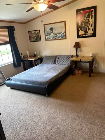 a living room with furniture and a painting on the wall