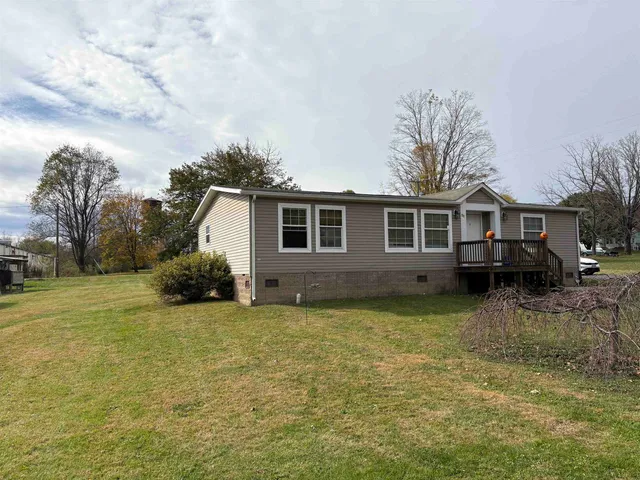 a view of a house with a yard and sitting area