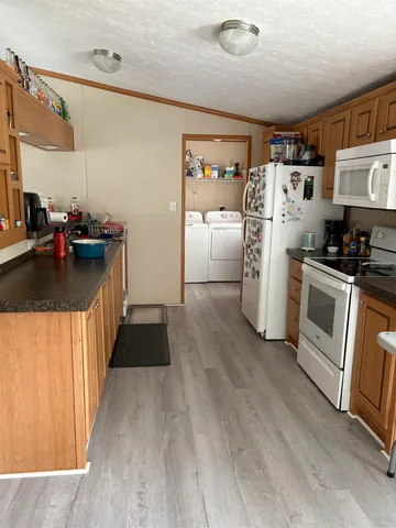 a kitchen with a refrigerator and a stove