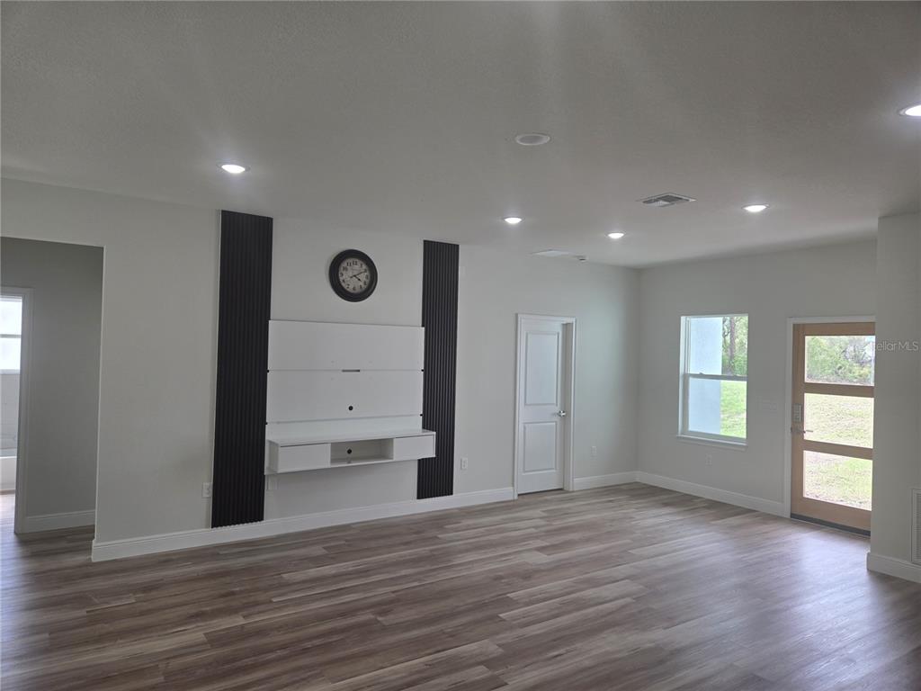 2644 Southwest 162nd Street Road Ocala, FL 34473 - Photo 11 of 47 a view of an empty room with a window and wooden floor
