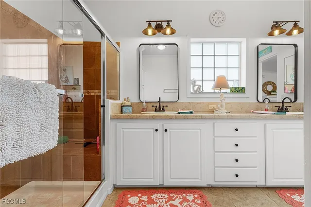 a bathroom with a double vanity sink and a mirror