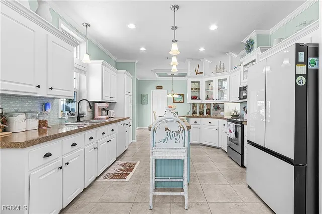 a kitchen with stainless steel appliances kitchen island granite countertop a sink and cabinets
