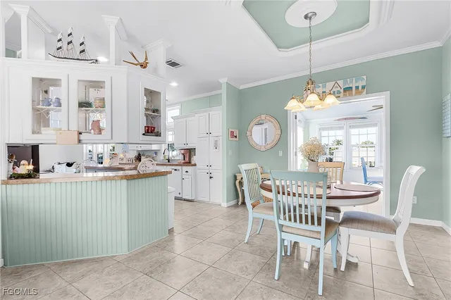a dining room with granite countertop a table and chairs