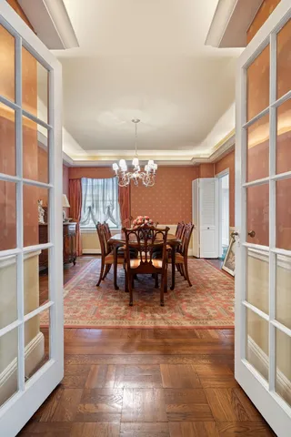 a view of a dining room with furniture and chandelier