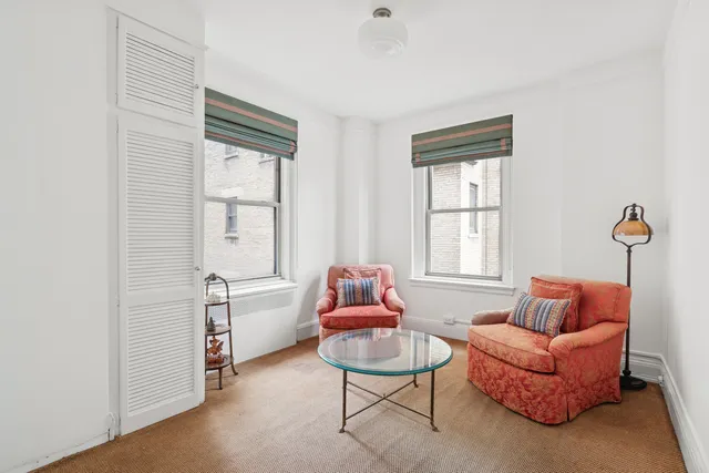a bedroom with a bed window and chair