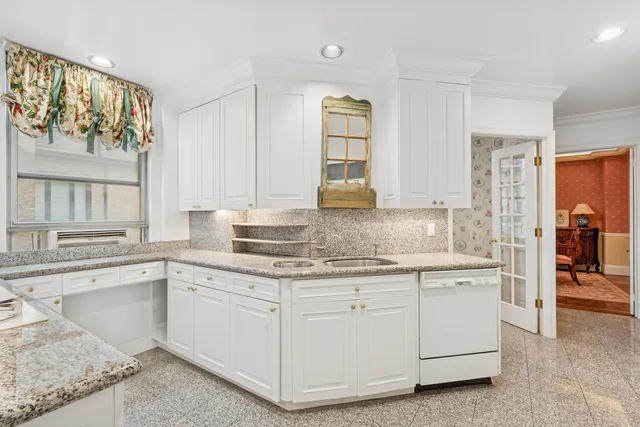 a view of a room with table and chairs