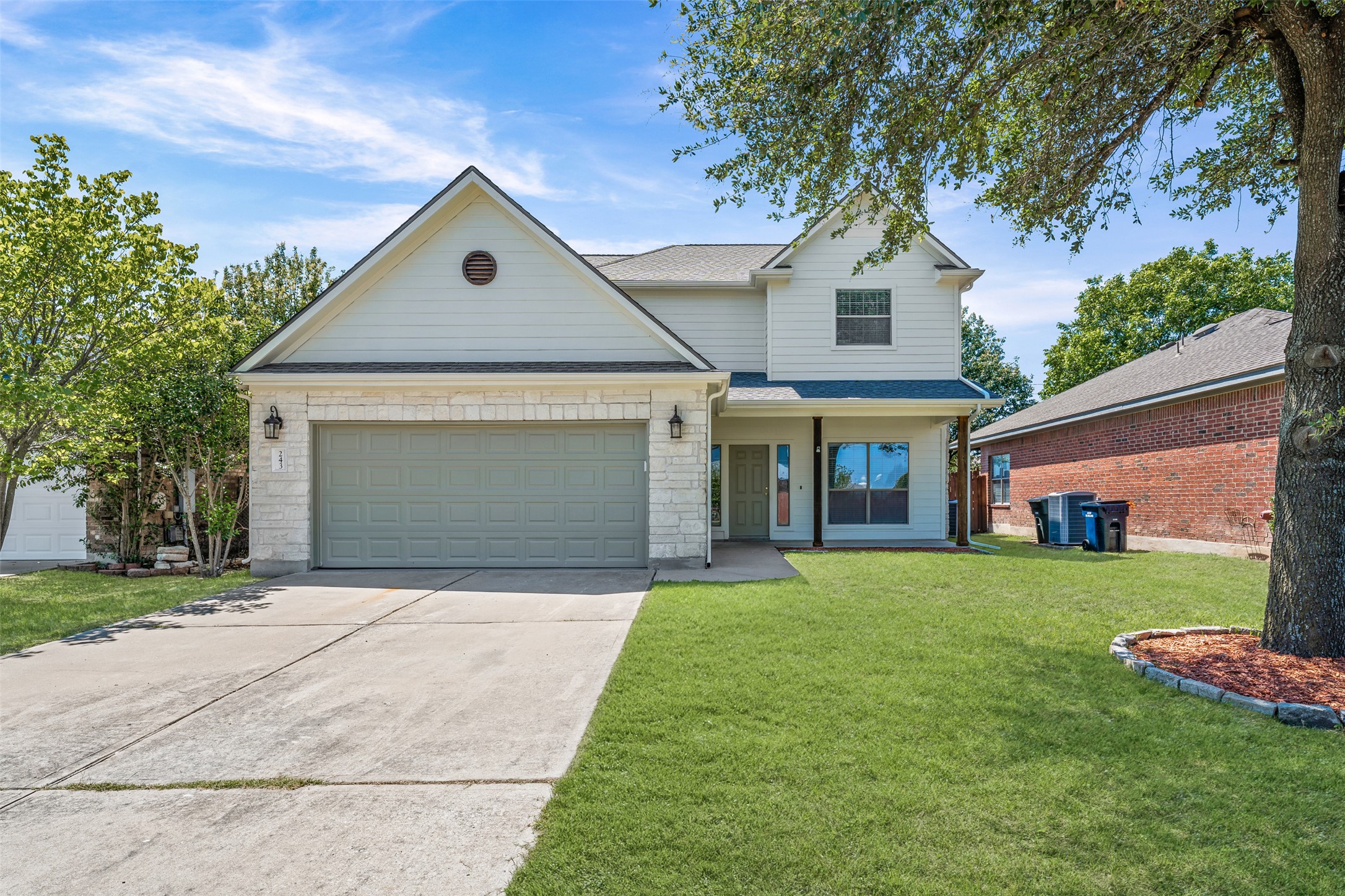 243 Engineers Pass Jarrell, TX 76537 - Photo 1 of 40 Two-story residence featuring light-colored siding and stone veneer accents
