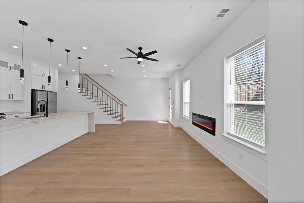 308 East 7th Street Dallas, TX 75203 - Photo 13 of 33 a view of an empty room with a fireplace and a window