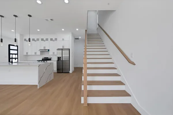 a view of kitchen with sink and refrigerator