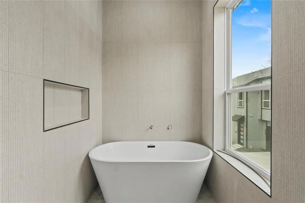 308 East 7th Street Dallas, TX 75203 - Photo 32 of 33 a white bath tub sitting next to a white sink