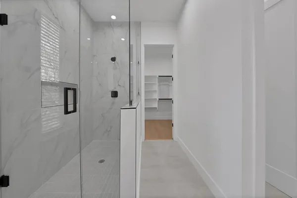 a bathroom with a shower and a glass door