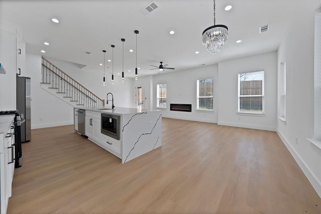 308 East 7th Street Dallas, TX 75203 - Photo 10 of 33 a view of a livingroom with wooden floor and stairs