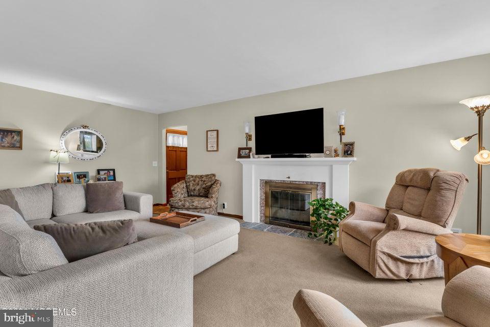 535 Carroll Fox Road Brick, NJ 08724 - Photo 7 of 31 a living room with furniture a fireplace and a flat screen tv