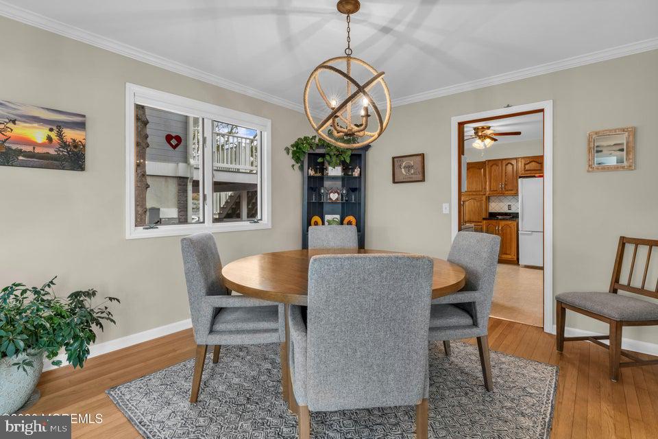 535 Carroll Fox Road Brick, NJ 08724 - Photo 10 of 31 a dining room with wooden floor a glass table and chairs