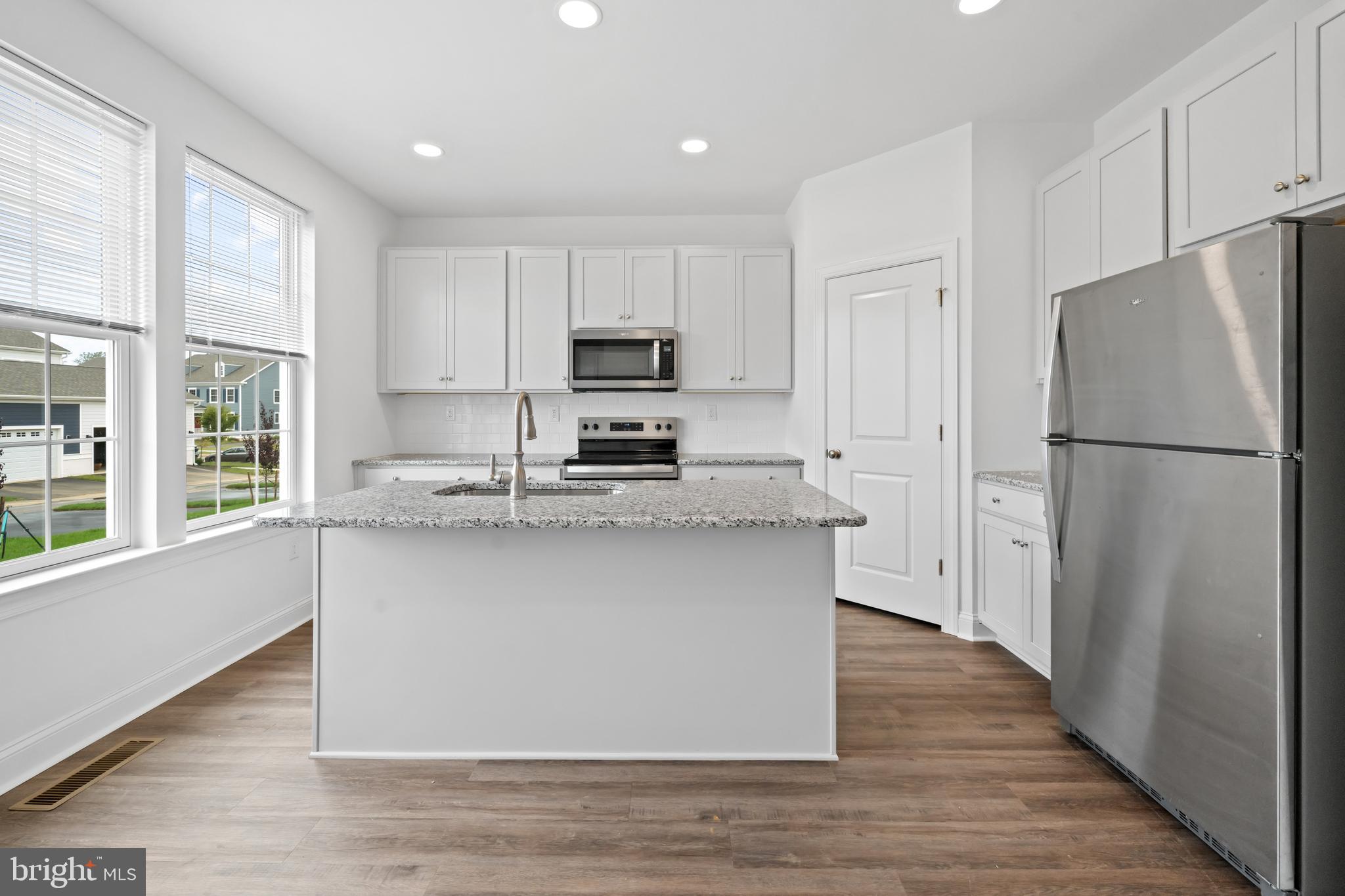 845 Mapleton Avenue Middletown, DE 19709 - Photo 11 of 30 a kitchen with stainless steel appliances a refrigerator sink and microwave