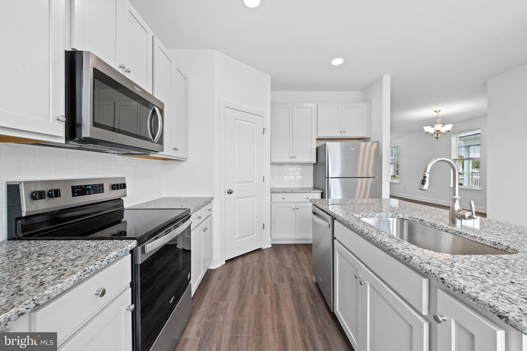 845 Mapleton Avenue Middletown, DE 19709 - Photo 13 of 30 a kitchen with granite countertop a sink stove and refrigerator