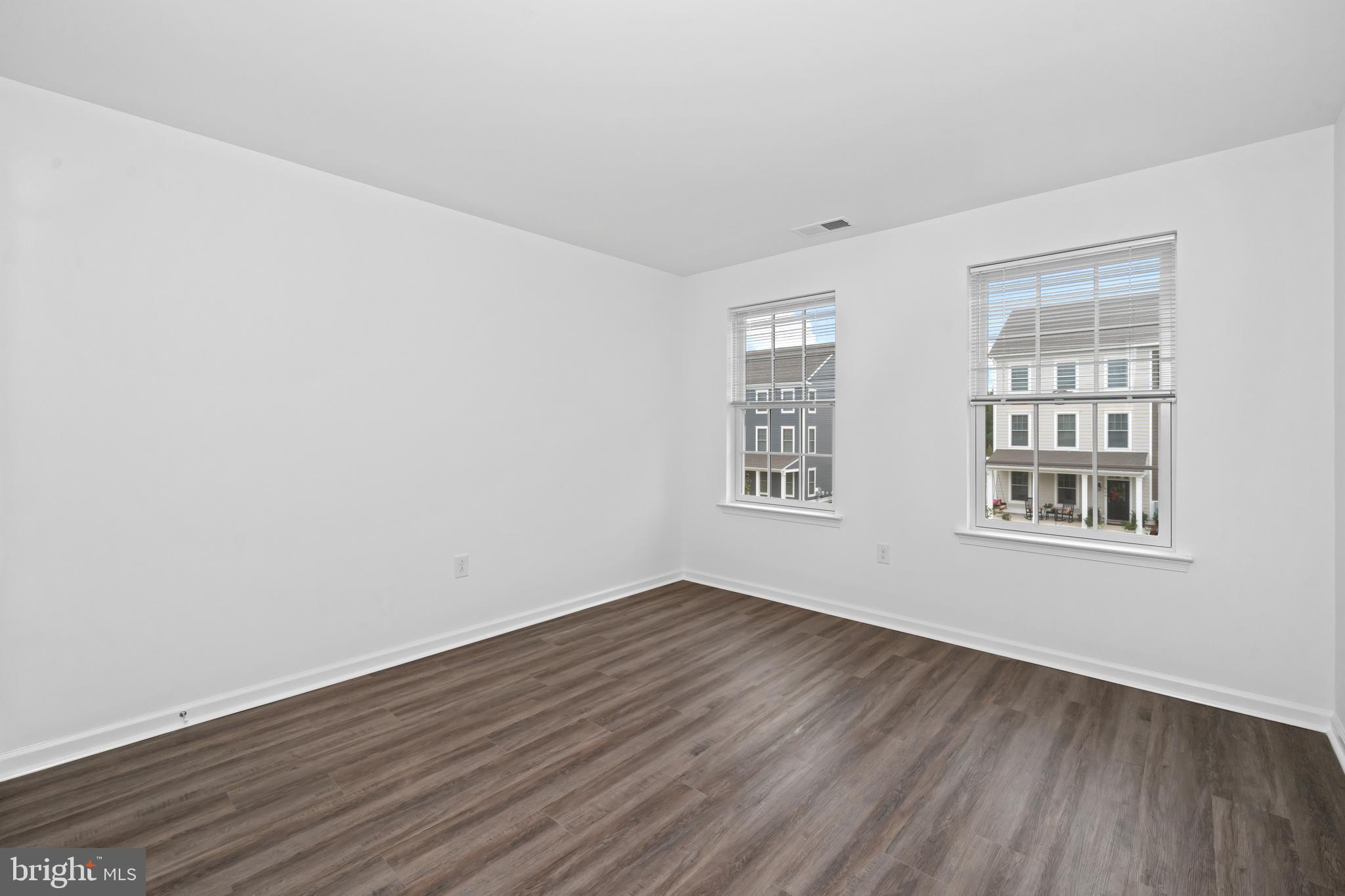 845 Mapleton Avenue Middletown, DE 19709 - Photo 22 of 30 an empty room with wooden floor and windows