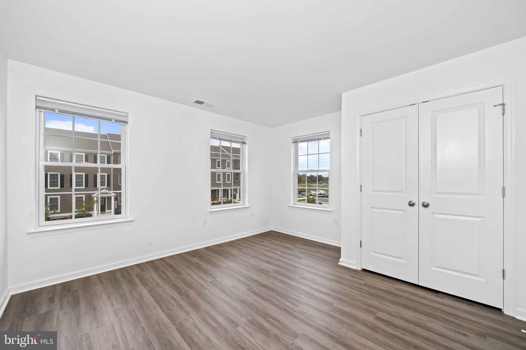 845 Mapleton Avenue Middletown, DE 19709 - Photo 24 of 30 a view of an empty room with wooden floor and windows