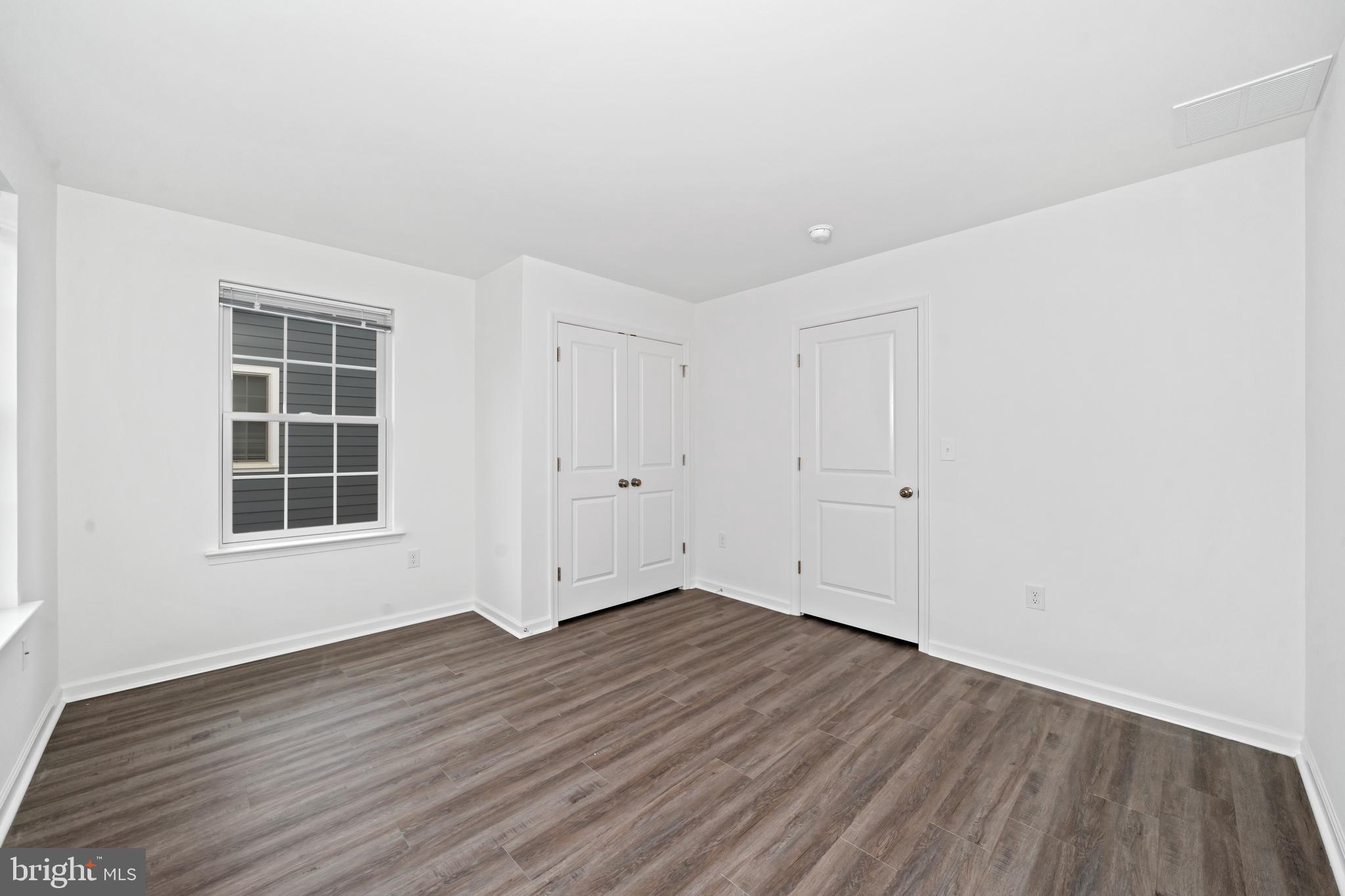 845 Mapleton Avenue Middletown, DE 19709 - Photo 26 of 30 an empty room with wooden floor and windows