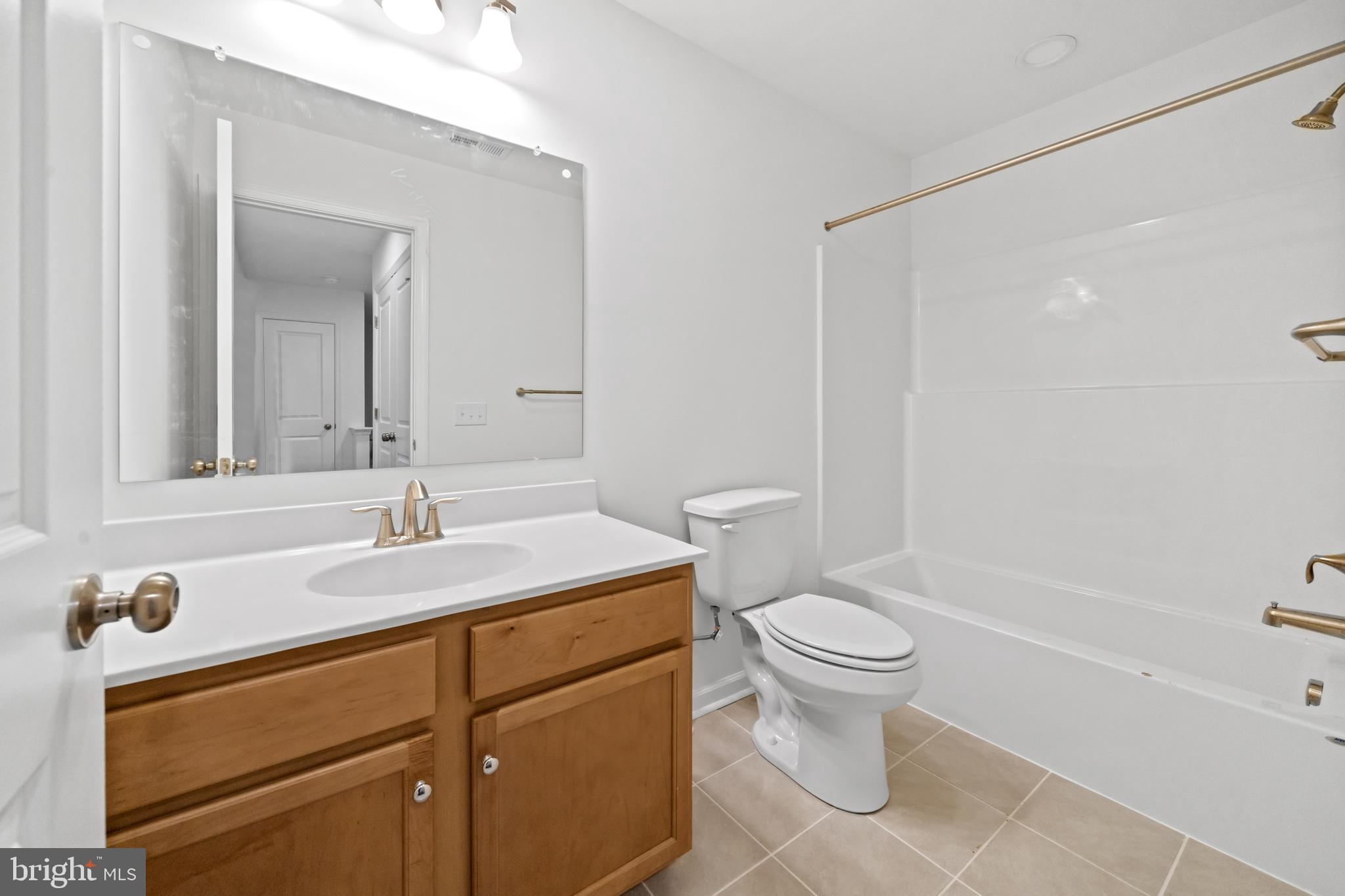 845 Mapleton Avenue Middletown, DE 19709 - Photo 27 of 30 a bathroom with a granite countertop sink a toilet and a mirror