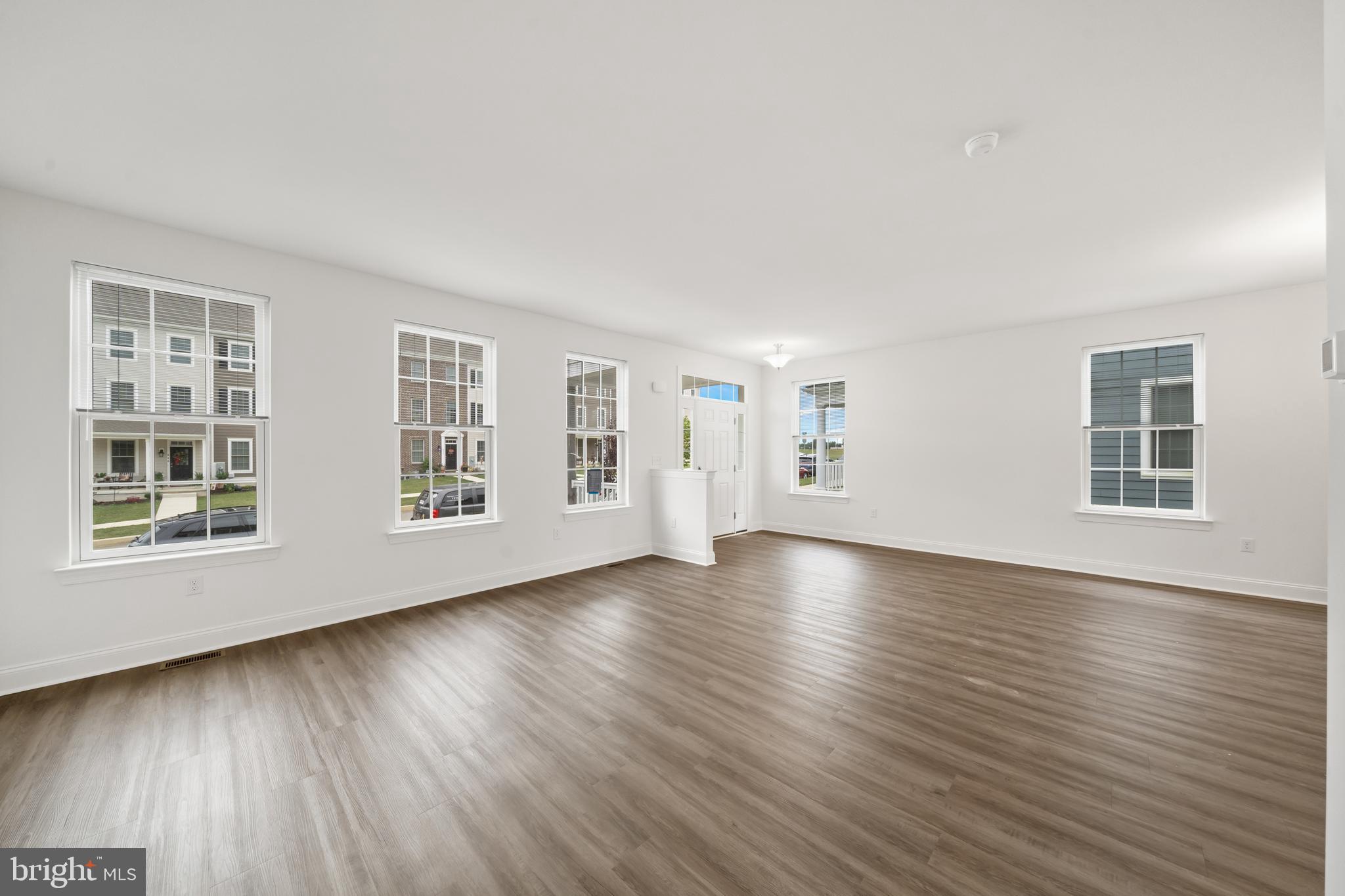 845 Mapleton Avenue Middletown, DE 19709 - Photo 6 of 30 a view of an empty room with wooden floor and windows