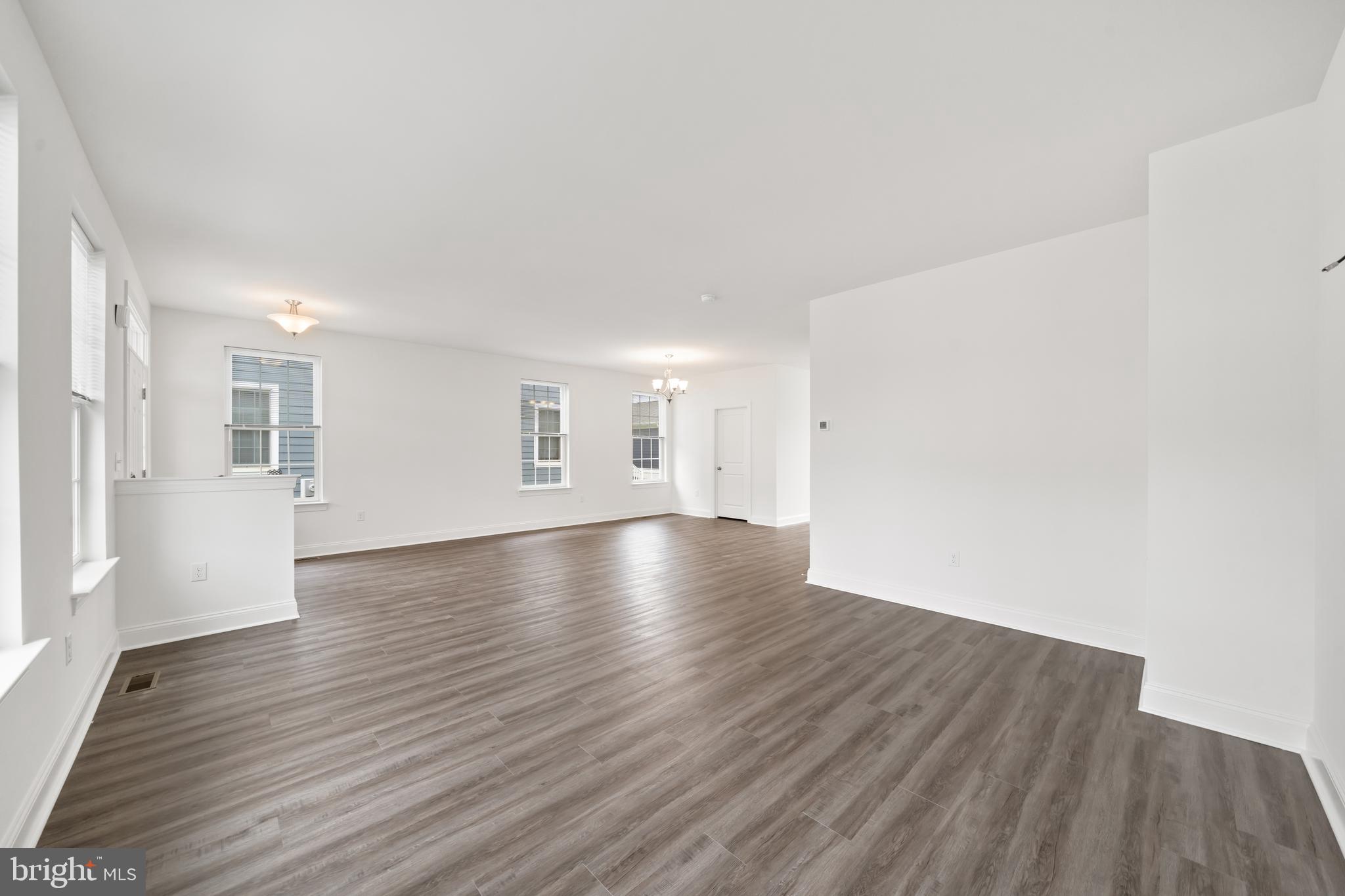 845 Mapleton Avenue Middletown, DE 19709 - Photo 9 of 30 an empty room with wooden floor and windows