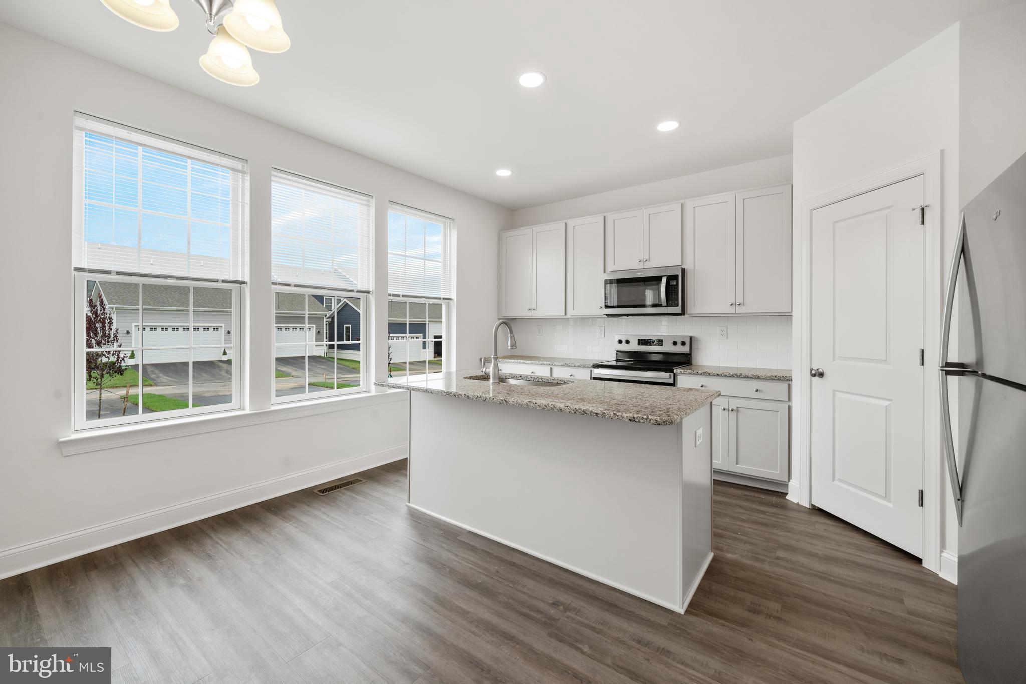 845 Mapleton Avenue Middletown, DE 19709 - Photo 10 of 30 a kitchen with stainless steel appliances granite countertop a stove a sink and a refrigerator