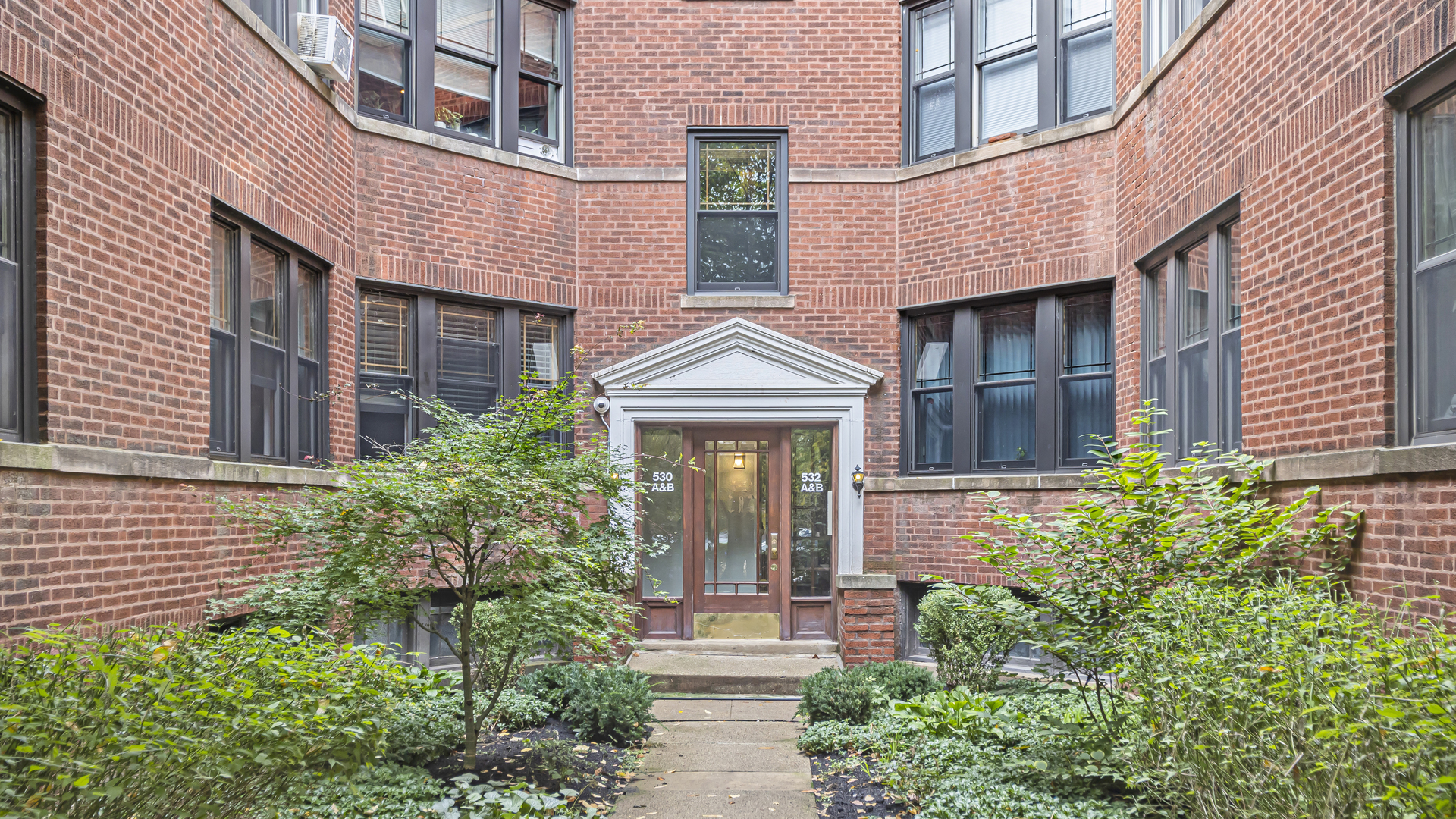 532 Sheridan Road, Unit 2B Evanston, IL 60202 - Photo 1 of 16 front view of a brick house with a large windows