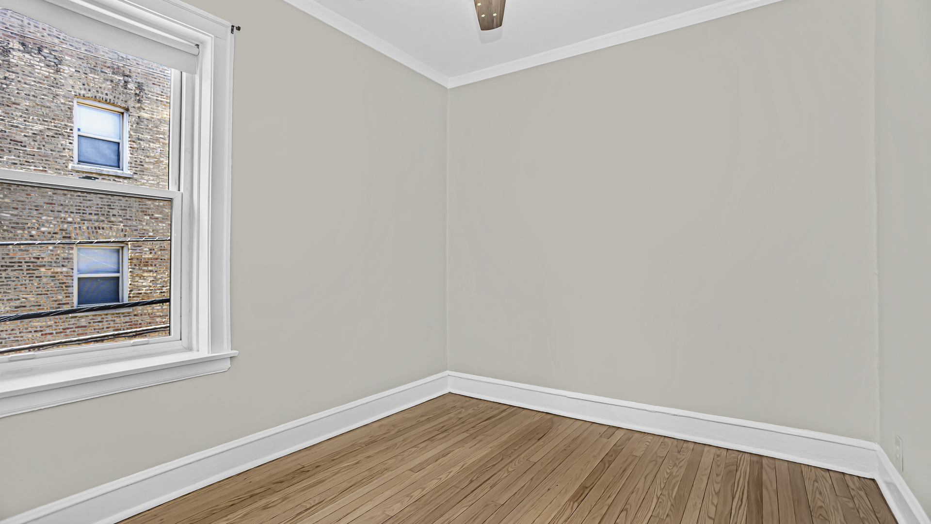 532 Sheridan Road, Unit 2B Evanston, IL 60202 - Photo 13 of 16 a view of an empty room with wooden floor and a window