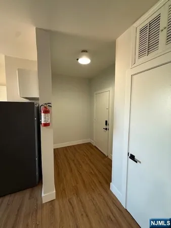 a view of a hallway with wooden floor
