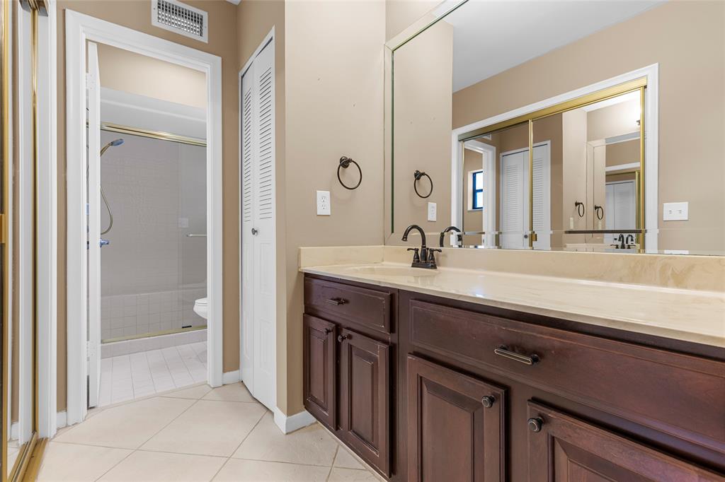 10971 Lake Front Place, Unit 10971 Boca Raton, FL 33498 - Photo 23 of 33 a bathroom with a sink a toilet and shower