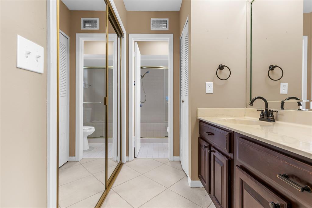 10971 Lake Front Place, Unit 10971 Boca Raton, FL 33498 - Photo 24 of 33 a en suite bathroom with a sink a mirror and a shower