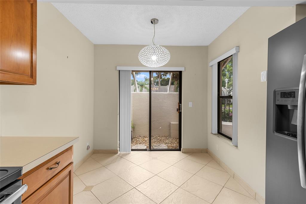 10971 Lake Front Place, Unit 10971 Boca Raton, FL 33498 - Photo 5 of 33 an empty room with entrance and windows