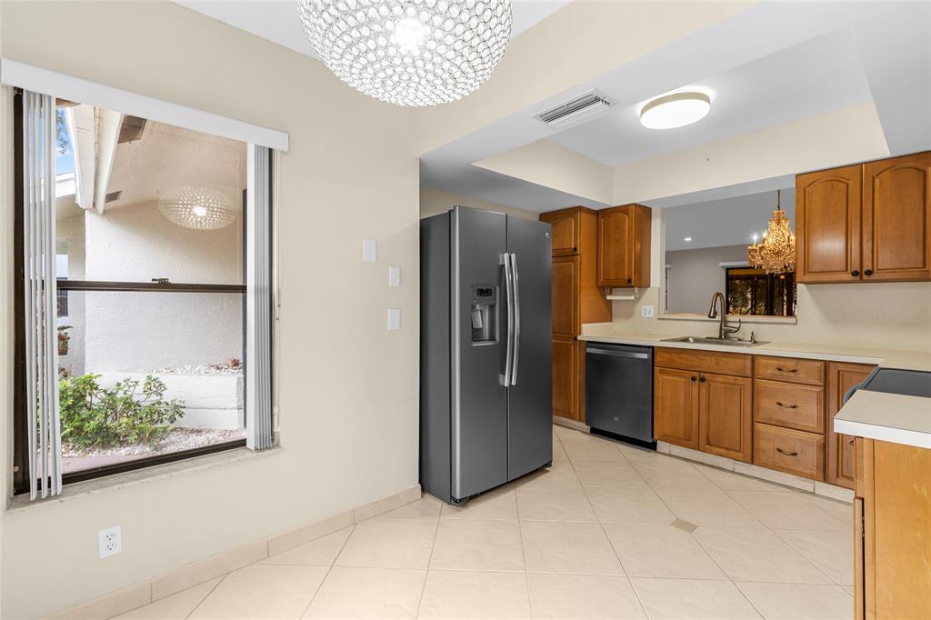 10971 Lake Front Place, Unit 10971 Boca Raton, FL 33498 - Photo 6 of 33 a kitchen with stainless steel appliances a refrigerator and a stove
