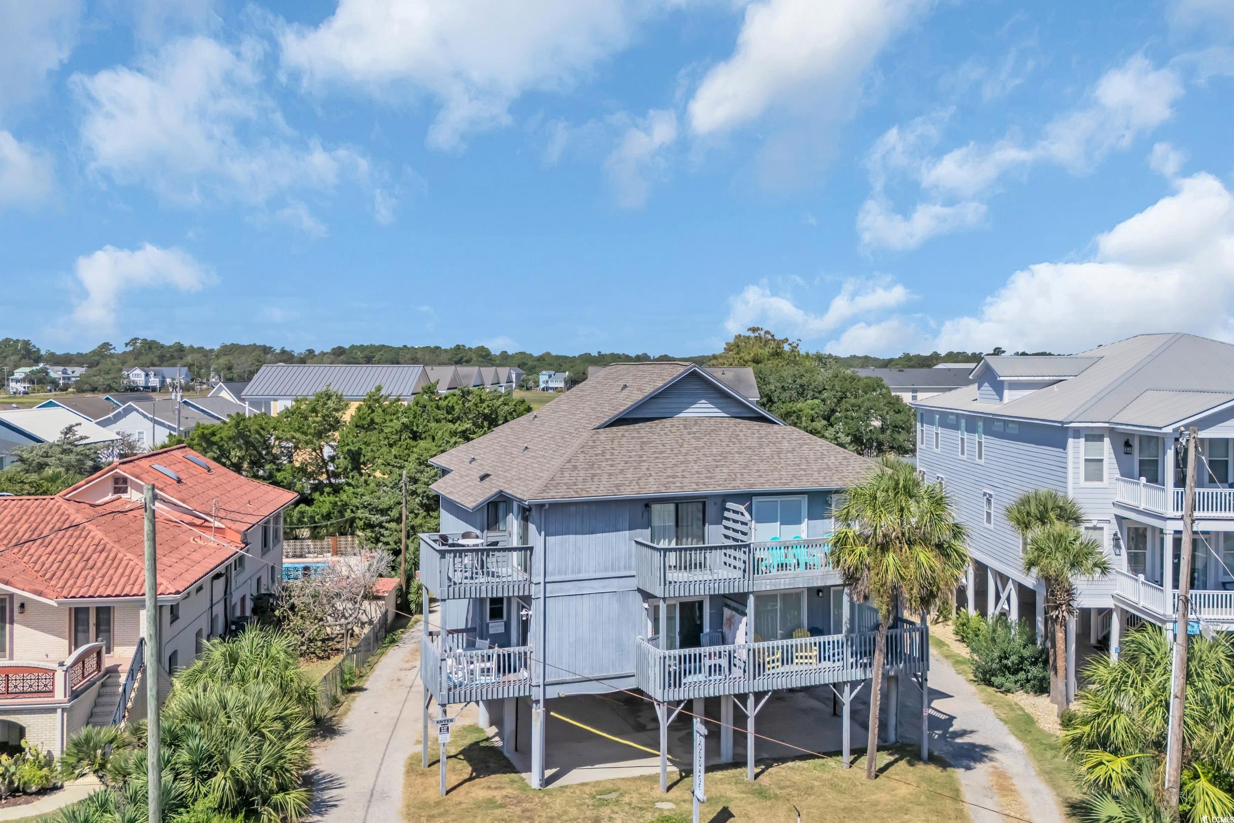 Rear view of property with a balcony, a residential view, and a shingled roof