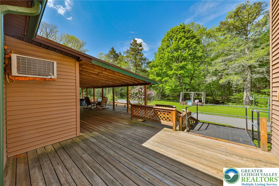 331 Cranberry Creek Road Cresco, PA 18326 - Photo 88 of 95 An inviting deck offers a vast space for outdoor relaxation and access to the verdant yard.