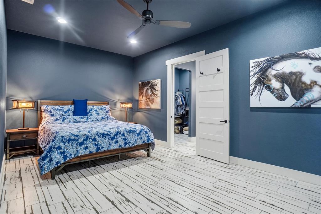 13240 Briar Road Azle, TX 76020 - Photo 31 of 39 a bedroom with a large bed and a wooden floor