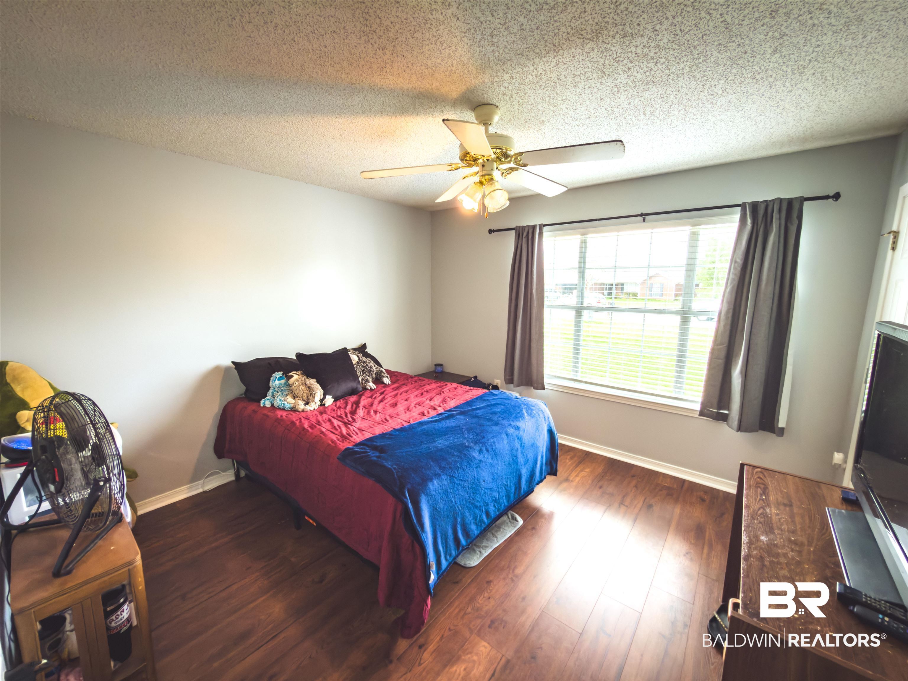 129 Pennbrooke Loop Foley, AL 36535 - Photo 11 of 44 Bedroom with dark wood finished floors, a textured ceiling, and ceiling fan