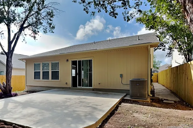 a view of a house with a backyard