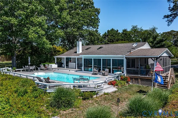 a view of a house with swimming pool and sitting area