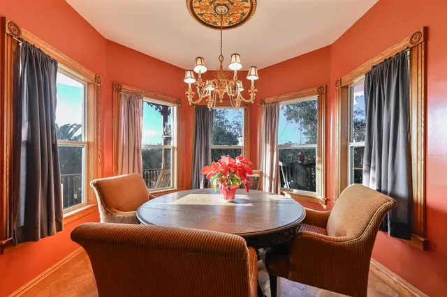 a bedroom with a bed and a couch next to a window