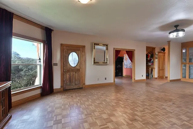 a view of a house with a big yard and potted plants