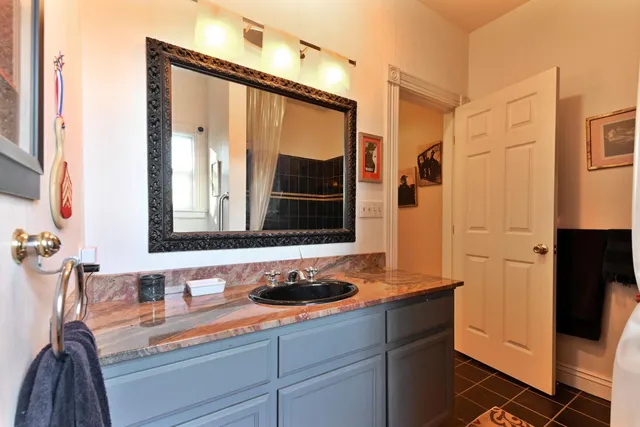 an aerial view of a house with swimming pool and garden