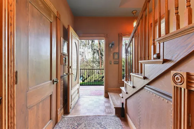 a kitchen with stainless steel appliances granite countertop a refrigerator a stove and a sink with wooden floor