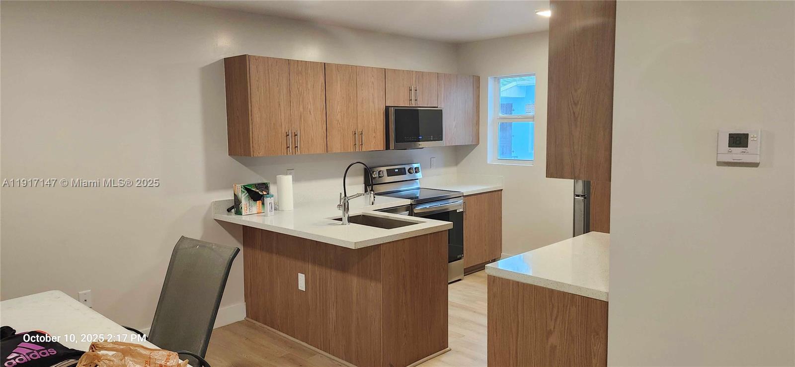 4557 Northwest 14th Avenue, Unit 4557 Miami, FL 33142 - Photo 4 of 13 a kitchen with a sink cabinets and a window