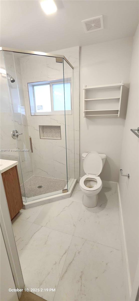 4557 Northwest 14th Avenue, Unit 4557 Miami, FL 33142 - Photo 6 of 13 a bathroom with a toilet and a shower