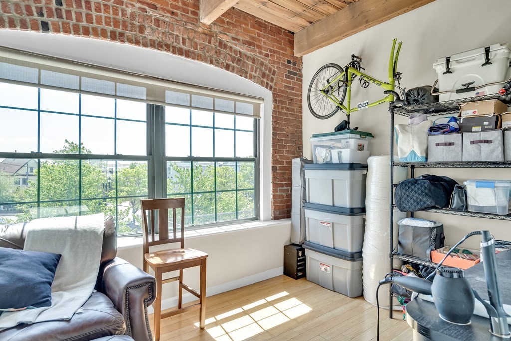 210 Broadway, Unit 301 Everett, MA 02149 - Photo 14 of 16 a living room with furniture and a window