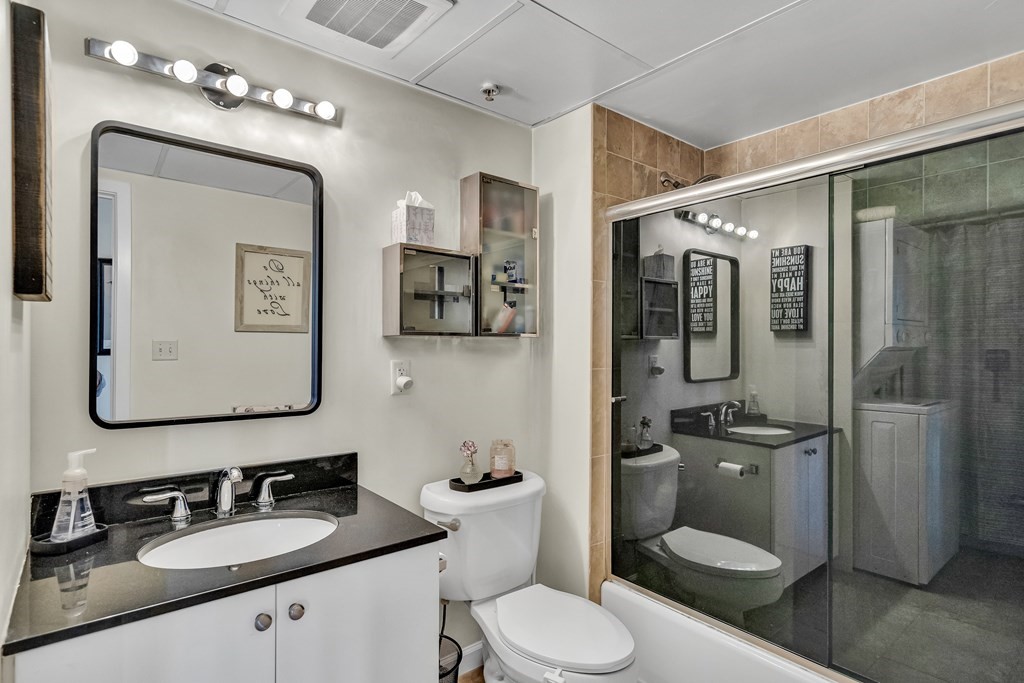 210 Broadway, Unit 301 Everett, MA 02149 - Photo 15 of 16 a bathroom with a toilet sink shower and mirror