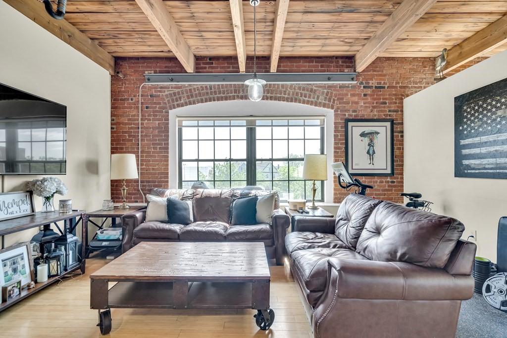 210 Broadway, Unit 301 Everett, MA 02149 - Photo 2 of 16 a living room with furniture and a large window