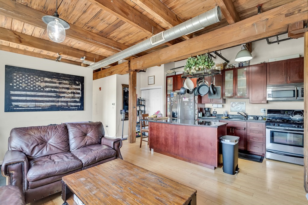 210 Broadway, Unit 301 Everett, MA 02149 - Photo 3 of 16 a living room with stainless steel appliances granite countertop lots of counter top space